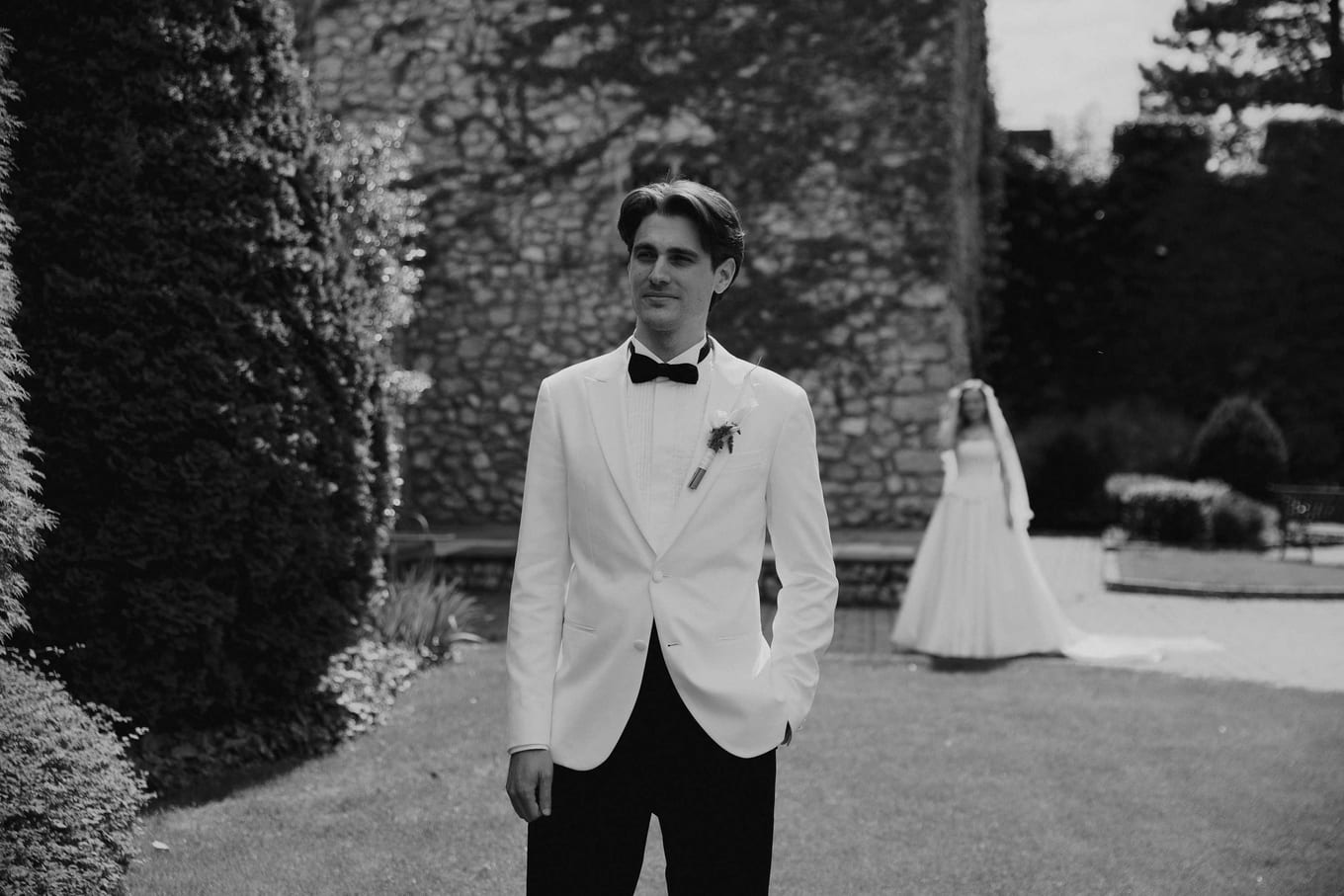 Groom turning as the bride approaches for the first look