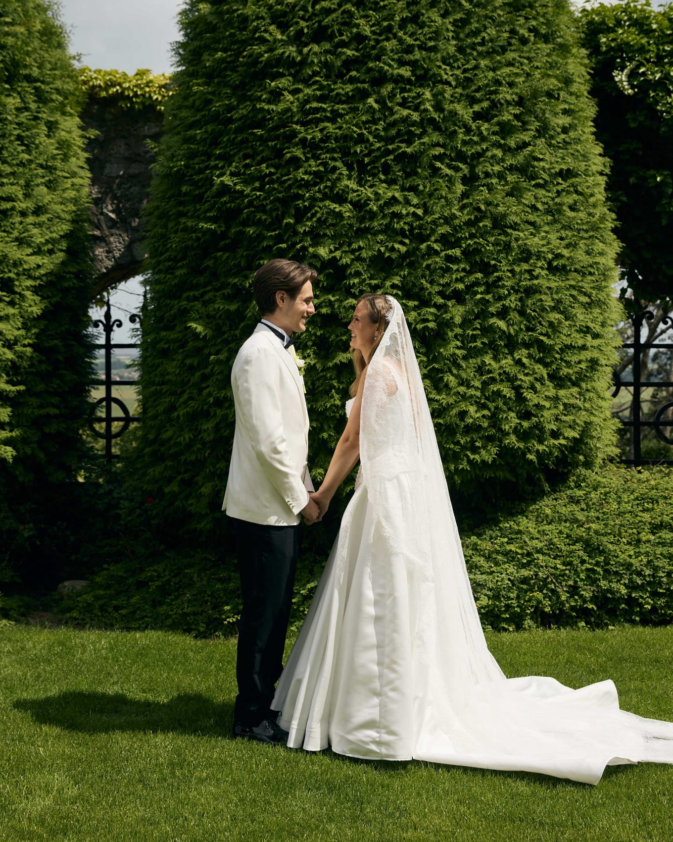 The couple face to face on the lawn after the first look