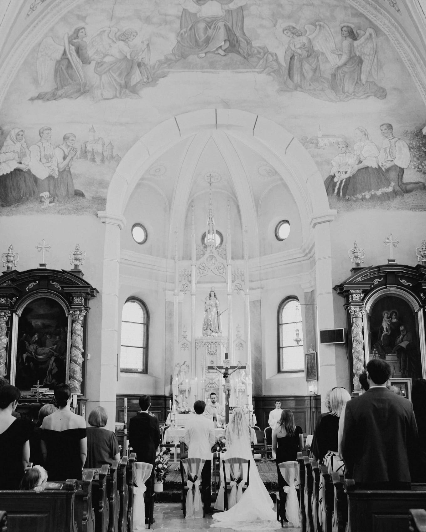 The nave and painted vault with the couple at the altar