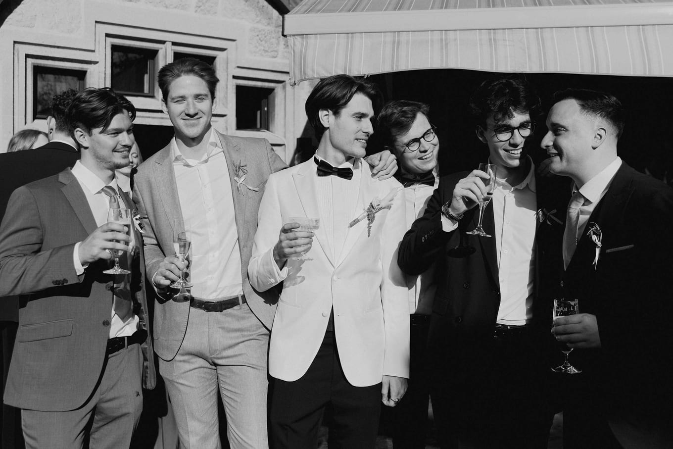 Groomsmen together with drinks at the reception