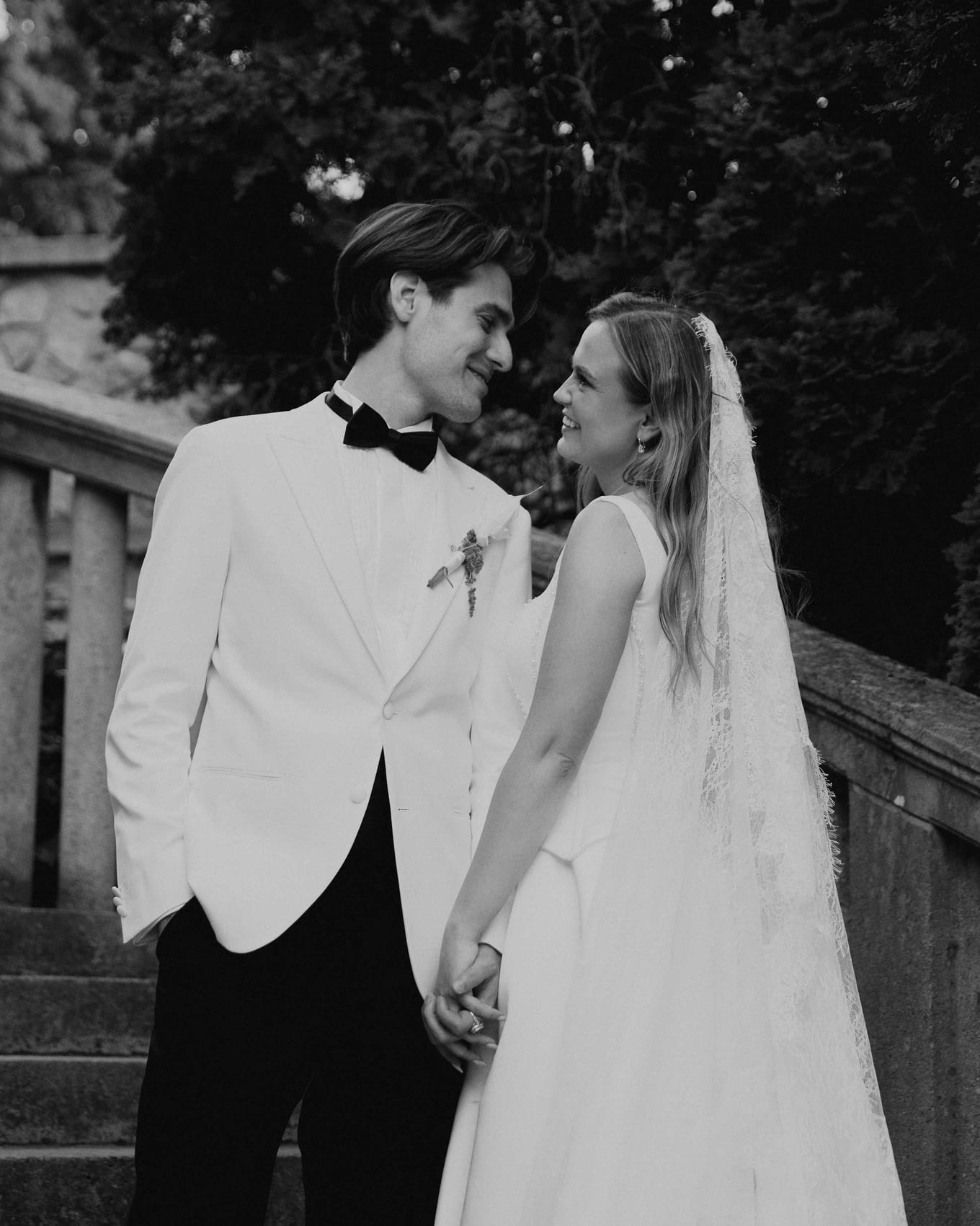 The couple laughing together on the stairs